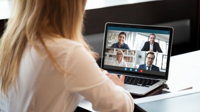 Frau sitzt vor dem PC, Online Meeting